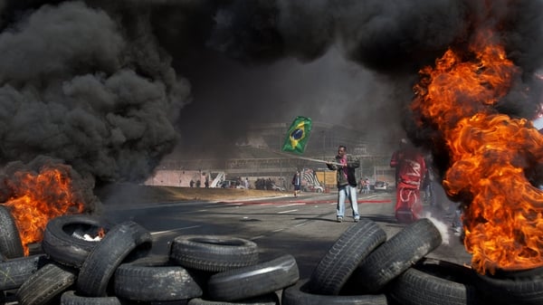 Protesters set fire to tyres on the road to the World Cup stadium in Sao Paulo