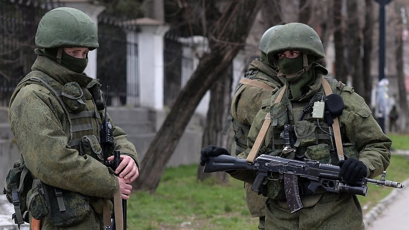 Russian soldiers patrol outside the navy headquarters in Simferopol on the Crimean peninsula in recent month