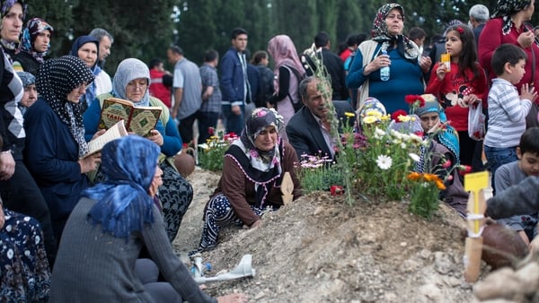 Relatives gather at the grave of one of the miners killed in the disaster