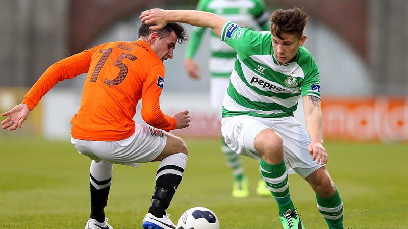 Luke Byrne goes past Graham Rusk as the Hoops moved to the top of the table