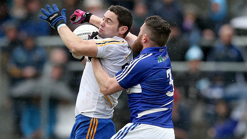 Seanie Furlong of Wicklow is tackled by Paul Begley of Laois