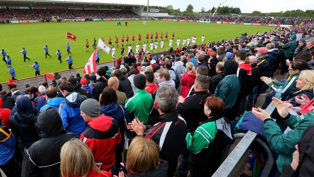 The Tyrone and Down teams parade before their Ulster SFC tie in Omagh