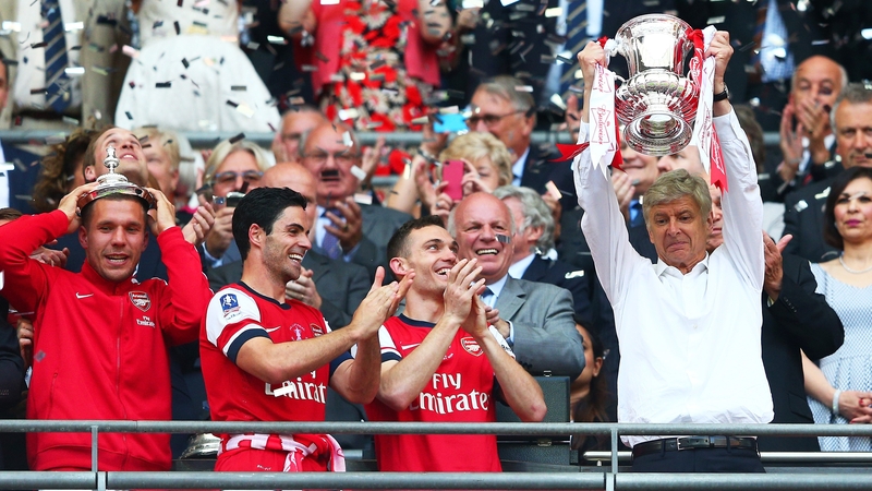 Arsene Wenger lifts the FA Cup, the club's first trophy in nine years
