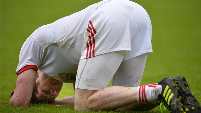 Tyrone's Mattie Donnelly falls to the ground at the final whistle, the game ended in a draw