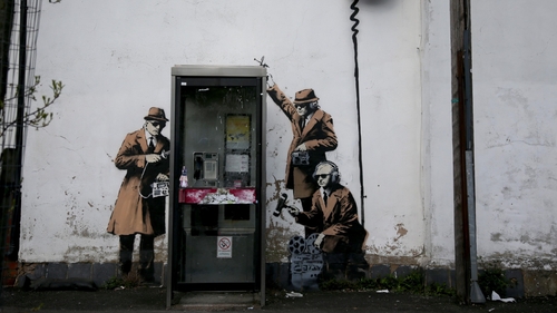 The creation shows three 1950s-style agents, wearing brown trench coats and trilby hats