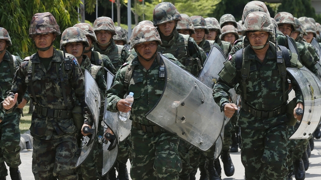 Thai soldiers guard the area during a meeting between the army and the main political rivals at the Army Club in Bangkok