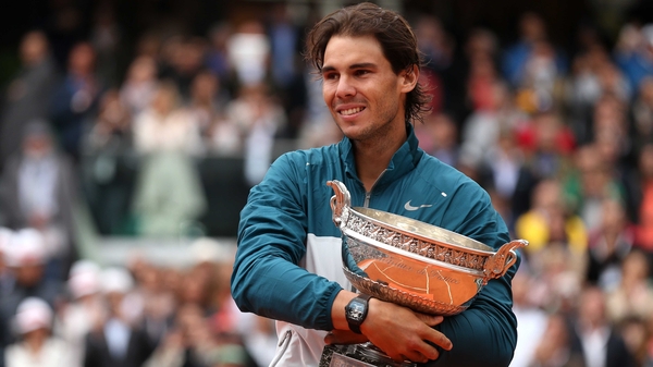 Rafael Nadal poses with the Coupe des Mousquetaires trophy after winning the 2013 French Open