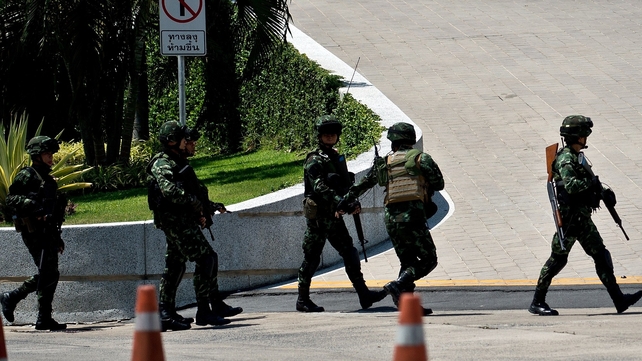 Soldiers keep guard during a meeting of the Thai Army chief with pro-government leader and anti-government protest leader