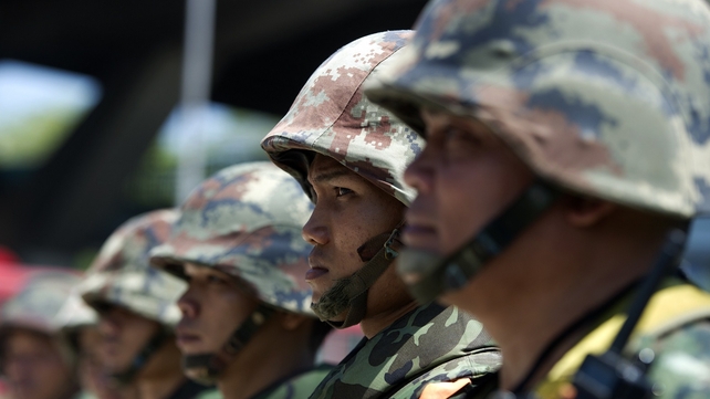 Thai soldiers stand guard as anti-government protest leaders meet with army chief General Prayut Chan-O-Cha at the Army Club