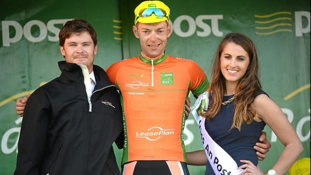 Marcin Bialoblocki, Velosure Giordana, is presented with the stage winners jersey by Miss An Post Rás Clonakilty Emma O'Sullivan, and John Inglis, Senior Technical Manager