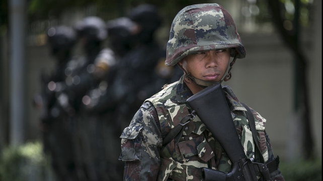 Thai soldiers stand guard near government buildings in Bangkok