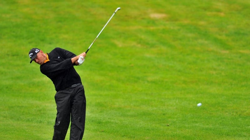 Thomas Bjorn plays his approach shot to the green on the fourth hole
