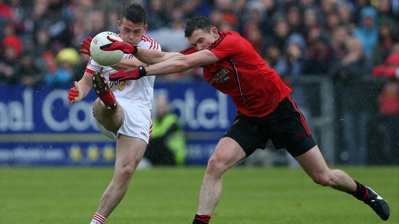 Tyrone's Darren McCurry with Down's Declan Rooney