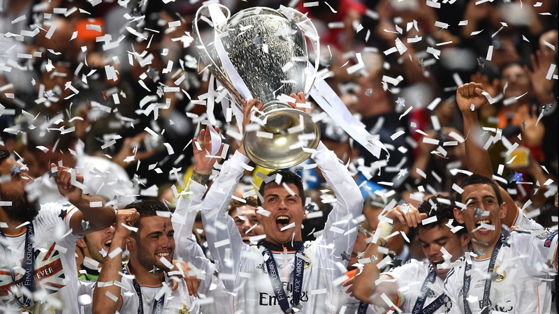 Real Madrid's Cristiano Ronaldo holds the Champions League trophy aloft