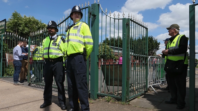 'Ello, 'ello, 'ello. Policemen stand guard outside London's ground in Ruislip