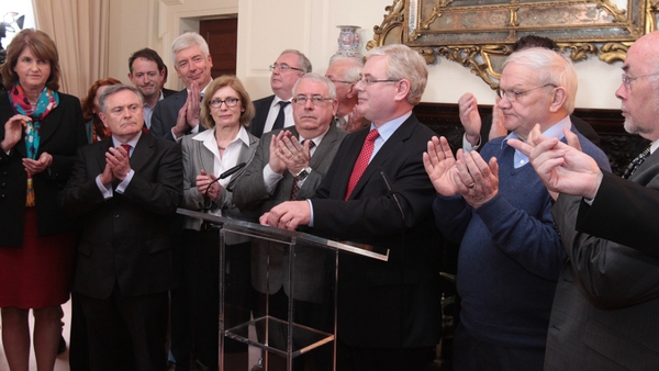 Labour party colleagues applaud after Eamon Gilmore's announcement