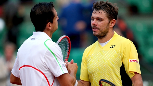 The vanquished Stanislas Wawrinka is consoled by Guillermo Garcia-Lopez