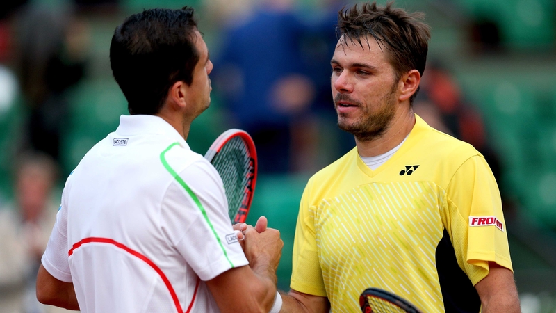 The vanquished Stanislas Wawrinka is consoled by Guillermo Garcia-Lopez