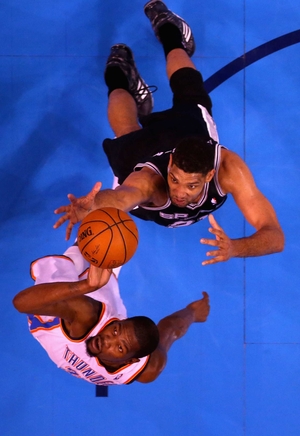 Tim Duncan of the San Antonio Spurs and Kevin Durant of the Oklahoma City Thunder go up for a loose ball in the first half during Game Four of Western Conference play-off