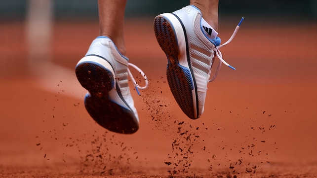 The shoes of Alize Lim of France as she serves during her match against Serena Williams on day one of the French Open