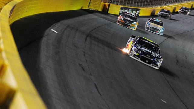 Jimmie Johnson, driver of the Lowe's Patriotic Chevrolet, leads the field during the NASCAR Sprint Cup Series at Charlotte Motor Speedway