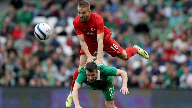 Seamus Coleman of Ireland is leap-frogged by Caner Erkin of Turkey