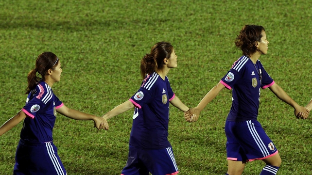 Japan celebrates by joining hands after they defeated Australia 1-0 during the AFC Women's Asian Cup Final