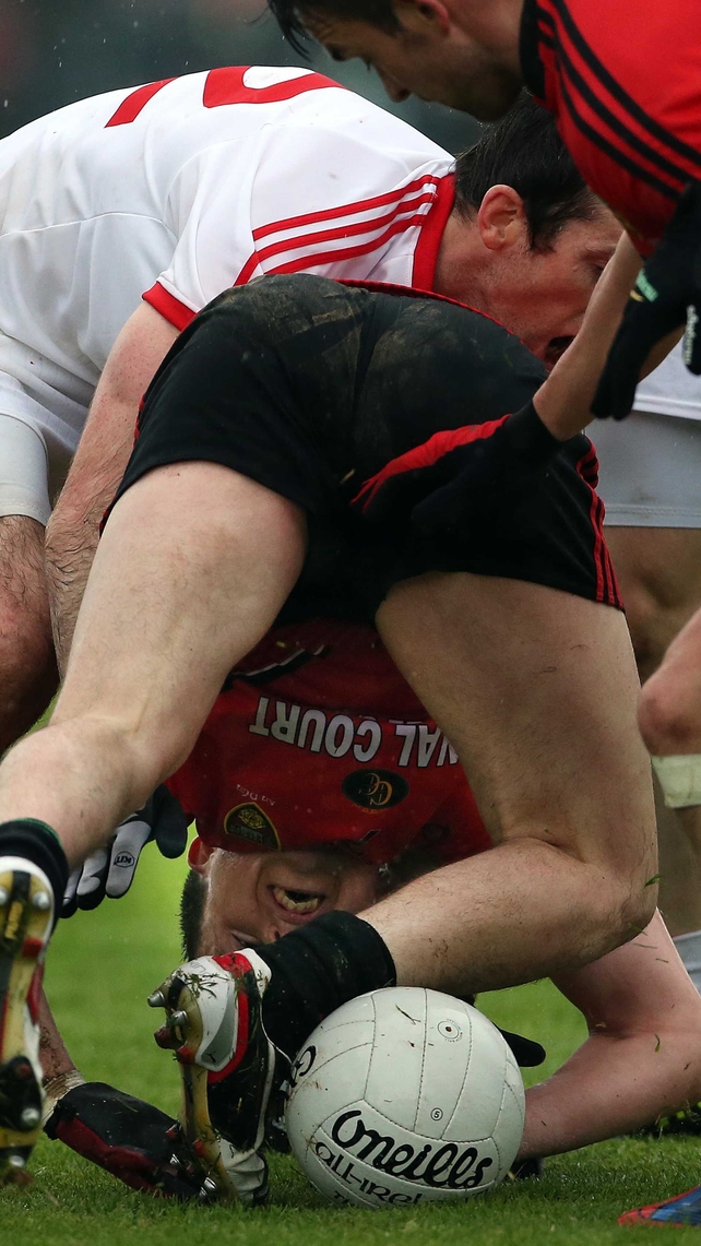 Down's Mark Poland with Tyrone's Justin Mahon during the Ulster SFC replay