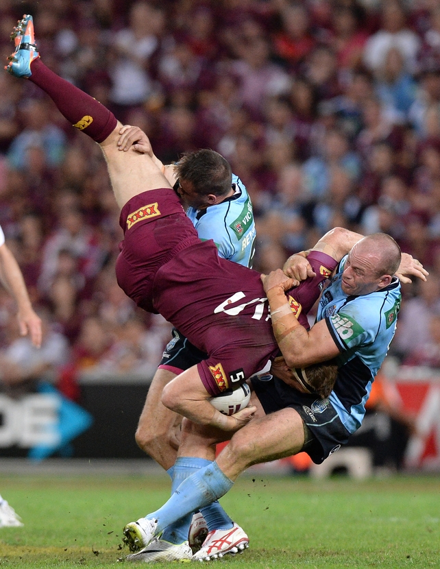 Brent Tate is picked up in the tackle by Josh Reynolds and Beau Scott during game one of the State of Origin series between the Queensland Maroons and the NSW Blues