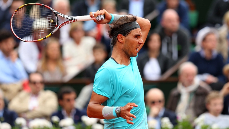 Rafael Nadal unleashes his trademark buggy-whip forehand against Dominic Thiem