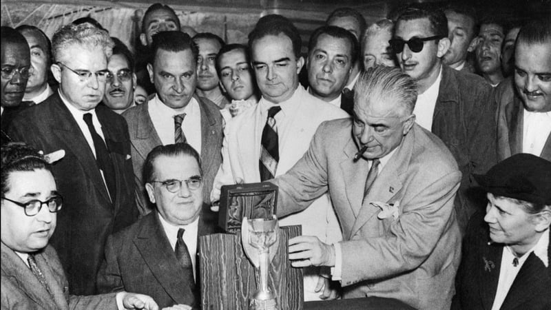 Representatives of the Italian football federation present the Jules Rimet Cup to their Brazilian counterparts