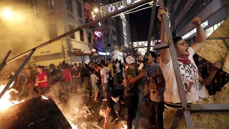 Turkish protesters set a barricade alight during an anti-government protest at Taksim Square last year