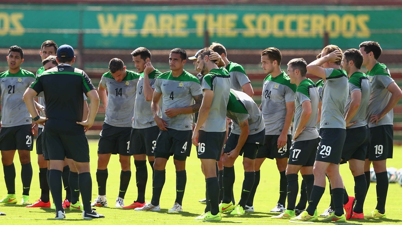 Australia coach Ange Postecoglou speaks with his team during training