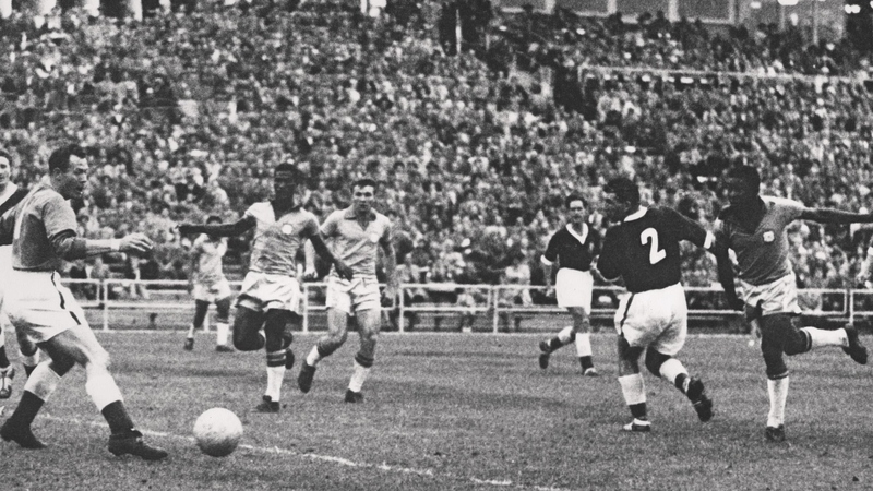 Pele kicks the ball past Welsh goalkeeper Jack Kelsey during the World Cup quarter-final between Brazil and Wales