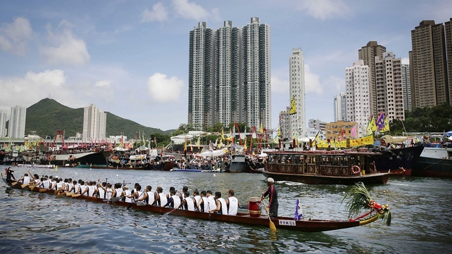 Racers compete in the Dragon Boat Festival in Aberdeen Harbour in Hong Kong on Monday
