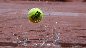 A ball rebounds off the tarpaulin covering Court Philippe Chatrier as the rains falls at the French Open in Paris