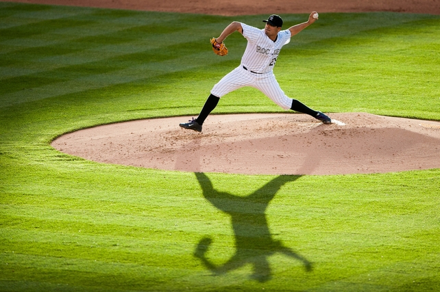 Jorge De La Rosa of the Colorado Rockies delivers a pitch against the Arizona Diamondbacks at Coors Field