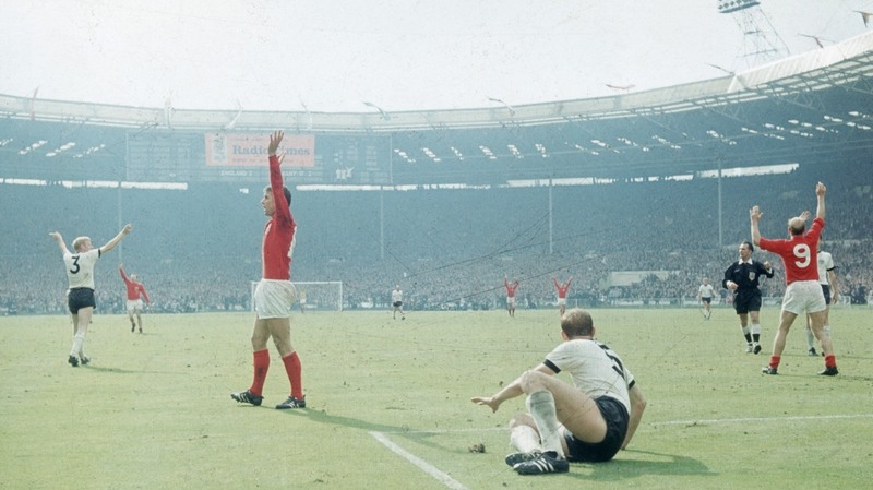 Geoff Hurst (L, in red) celebrates scoring his third goal of the final match