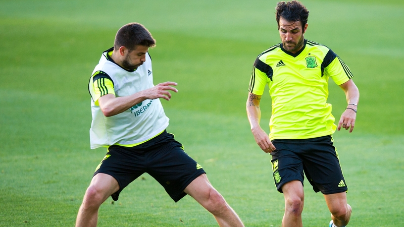 Gerard Pique (L) duels for the ball with Cesc Fabregas of Spain during a training session last week