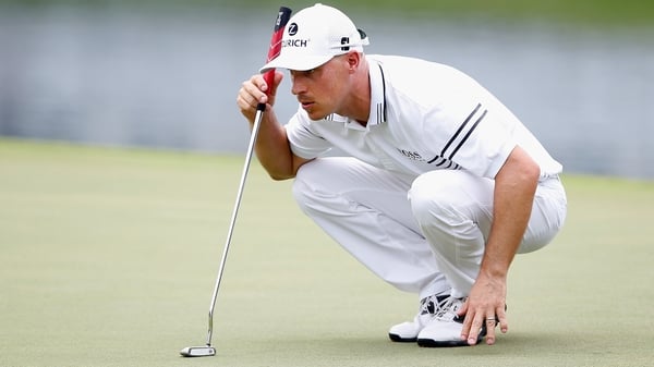 Ben Crane lines up a putt on the 18th green during the second round