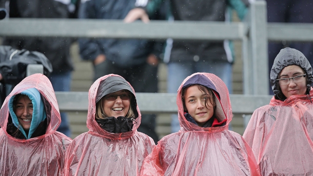 Fans shelter from a rain shower on the Hill at Croke Park on Sunday