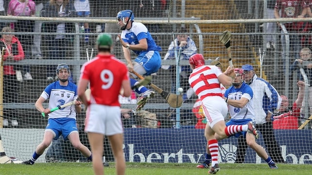 Waterford's Stephen O'Keeffe rushes out to block a penalty from his Cork counterpart Anthony Nash