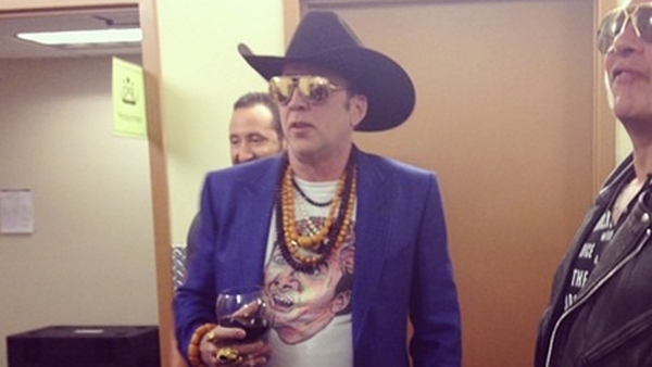 Nicolas Cage wearing a Nicolas Cage t-shirt backstage at a show