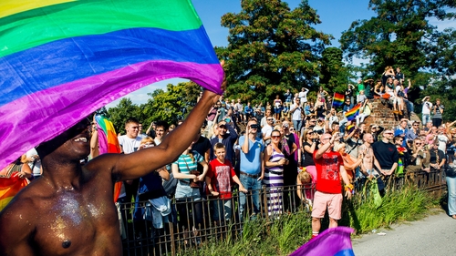 Participants of the Copenhagen Pride Parade walk through a street in Copenhagen, Denmark last August