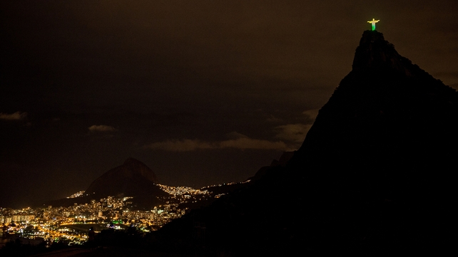 The statue of the Christ the Redeemer in Rio, lit with the colours of Brazil's flag