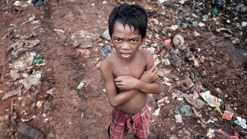 A young boy scavenges in a Cambodia dump