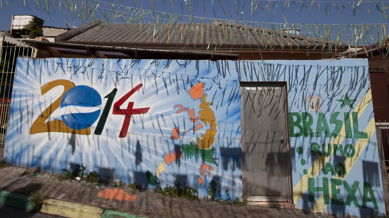 A decorated street with murals and banners in the Brasilandia favela