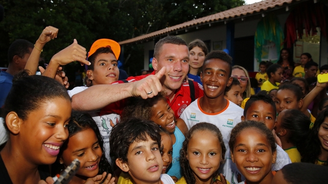Germany's Lukas Podolski visits a school and kindergarten in Bahia, Brazil