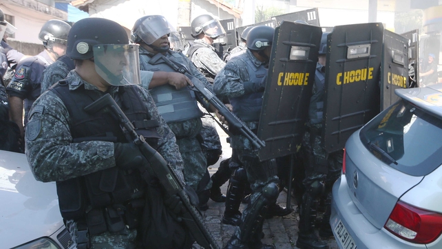 Brazilian police react to a protest ahead of the World Cup