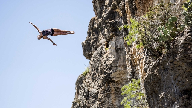 Cesilie Carlton dives from the 20m platform at Hells Gate during a training session of the second stop of the Cliff Diving World Series